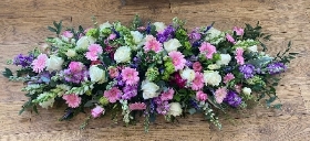 Purple white and pink casket spray